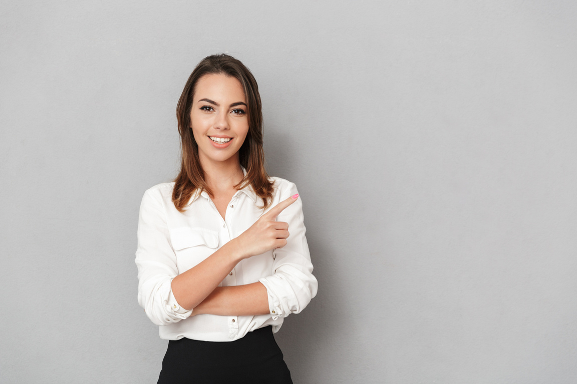 Happy Young Business Woman Pointing.